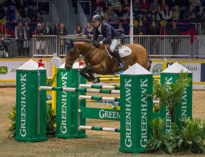 Ian Millar and Star Power clear the Greenhawk Oxer en route to victory in the first round of the Greenhawk Canadian Show Jumping Championships tonight at Toronto's Royal Horse Show. Photo: BenRadvanyi.com (CNW Group/Royal Agricultural Winter Fair)