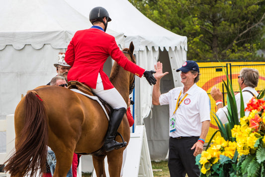 Mclain Ward (USA) and Team chef d'equipe, Robert Ridland high five after a gold medal win at the OLG Caledon Pan Am Equestrian Park during the Toronto 2015 Pan American Games in Caledon, Ontario, Canada.