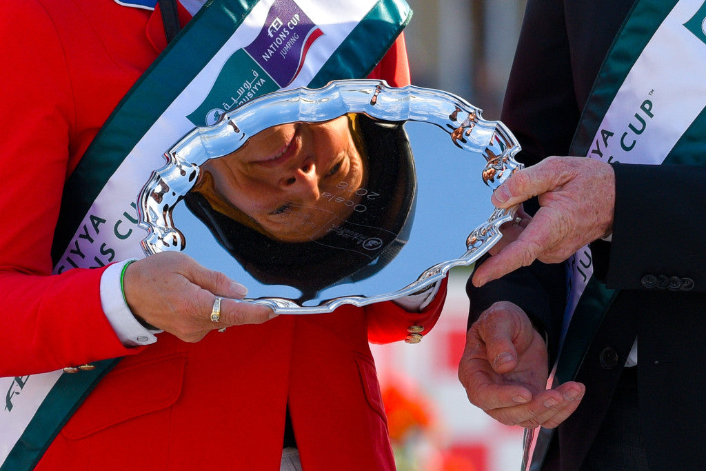 Furusiyya FEI Nations Cup 2016 - Ocala, Floirda, USA - 19/02/16 - Beezie Madden is reflected in the Silver Salver after Team USA won the Furusiyya FEI Nations Cup 2016 at HITS Post Time Farm. Mandatory Credit: FEI/Scott A. Miller