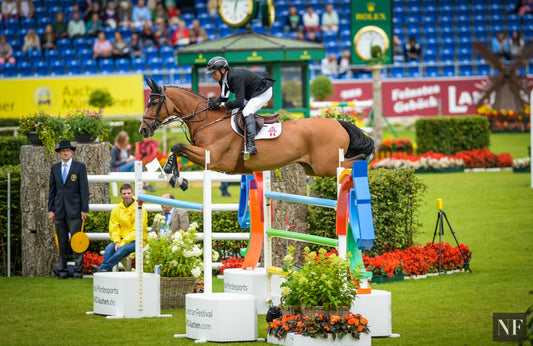 Lamaze and Fine Lady clear the Round 1 oxer that gave many other riders trouble.