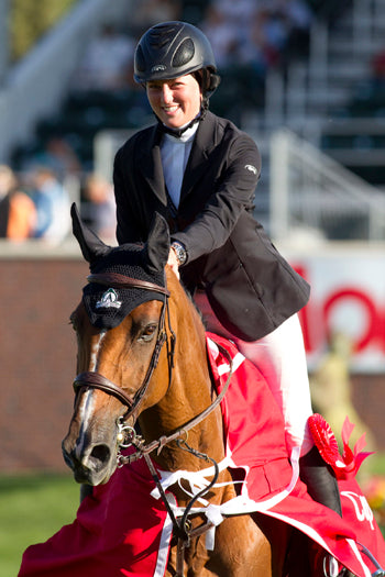 Caitlin Ziegler with Valencia in their victory lap at Spruce Meadows 